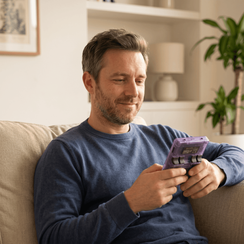 Person playing the Ssiki Pro 2.0 R36S retro gaming console at home
